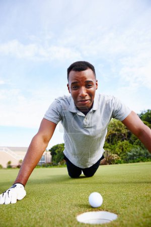Photo for Man, sports and miss hole in golf, sad for fail or loss with expression, competition and disappointment. Mistake, disaster and challenge with ball on grass, African athlete and lose game outdoor. - Royalty Free Image