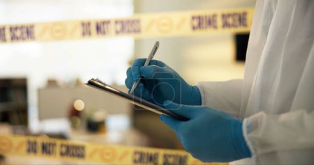 Hand, house and crime scene with writing for evidence or notes in robbery for evidence, safety and report. Forensics, police tape and investigation at home for dna, analysis and criminal activity