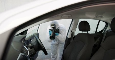 Photo for Forensic, investigation and photography of evidence in crime scene car for accident, burglary and research analysis. Science, csi and photographer with pictures in transport vehicle for observation. - Royalty Free Image