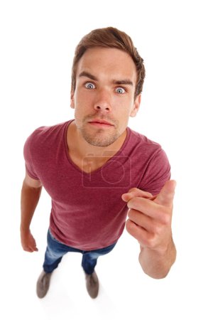 Stress, hand pointing and portrait of angry man in studio frustrated, annoyed or defensive on white background. Face, top view or male model with aggressive reaction conflict, trauma or confrontation.