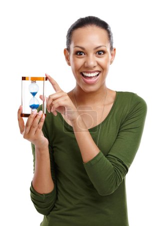 Photo for Portrait, woman and holding sand hourglass with excited gesture of running time. Surprised, person and hands on face for countdown of vacation decision with passing minute in white studio background. - Royalty Free Image