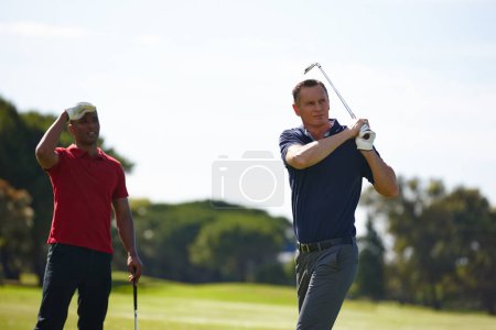 Photo for Men, sports and golf stroke outdoor for competition on green grass for training or exercise. People, athlete and golfer with club driver on lawn for professional contest or international match. - Royalty Free Image
