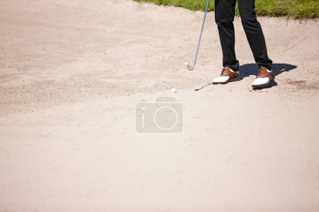 Photo for Golf, club and bunker with ball for shot with closeup of legs on pitch for recreational hobby. Sport, driving range and sand with man on course for accuracy with practise for skill development. - Royalty Free Image