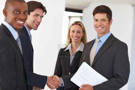 Photo for Business, document and handshake with colleagues and smile for deal, realtor or property or investment. Male person, team or shaking hands at house with paper or agreement, real estate with diversity. - Royalty Free Image