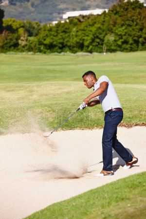 Photo for Man, swing and club on golf course in sand pit for par, bogey or stroke with grass field in nature. Young male person, golfer or sports player hitting ball out for strike, point or tough outdoor shot. - Royalty Free Image