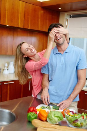 Photo for Happy, man and woman in playful, smile and cooking in kitchen at home for dinner, plans and family. Married couple in preparing, food or salad for healthy, eating and nutrition in house with love. - Royalty Free Image