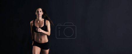 Photo for Fitness, mockup and portrait of woman in studio running for competition, race or marathon training. Sports, workout and female athlete with cardio exercise for health or wellness by black background - Royalty Free Image