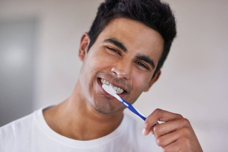 Happy, portrait and man with toothbrush in bathroom for dental hygiene, gum disease and oral care. Health, mouth and face of person brushing teeth for wellness, cleaning and fresh breath in home.
