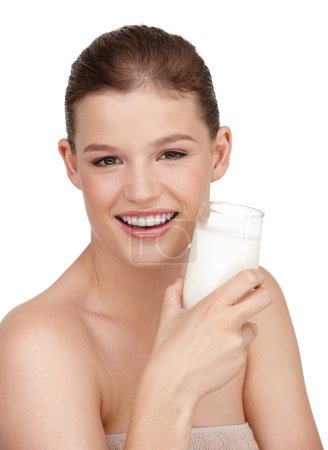 Photo for Woman, glass of milk and smile in studio portrait for healthcare, skincare or beauty and cosmetics. Female person, happy or satisfied with cup of dairy for immune system, dermatology and wellness. - Royalty Free Image