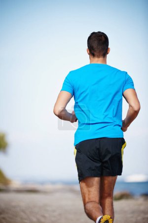 Photo for Sporty, man and jogging in outdoor for exercise, health and wellness in nature for workout or fitness. Male athlete, training and cardio with endurance, muscles and strength for healthy living or gym. - Royalty Free Image