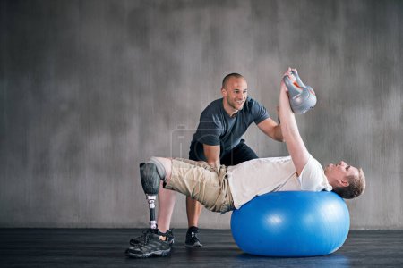 Photo for Trainer, man with a disability and prosthetic leg and dumbbell in physiotherapy, studio and gym ball. Male people, physiotherapy and amputee for wellness, fitness and exercise in rehab center. - Royalty Free Image
