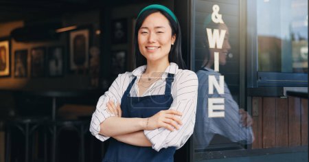 Photo for Happy asian woman, cafe and small business owner by door in confidence for management. Portrait of young female person or waitress smile with arms crossed by professional restaurant or coffee shop. - Royalty Free Image