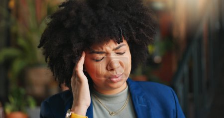 Photo for Frustrated black woman, headache and afro in stress, anxiety or mistake for business pressure at cafe. Face of African female person with migraine, pain or depression in mental health at coffee shop. - Royalty Free Image