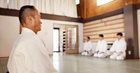 Japanese, men and aikido practice dojo or professional discipline, martial arts or black belt. Sensei, students and gee uniform in Tokyo for fight education as athlete or strong, fit or protection.