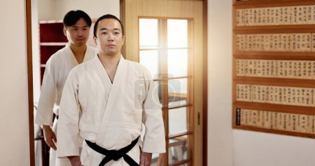 Photo for Black belt students, training and respect in dojo for aikido practice, discipline or self defense. Martial arts combat, Japanese people learning and workout for fighting class and group education. - Royalty Free Image