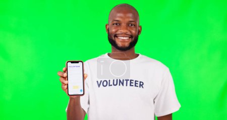 Photo for Black man, phone and social media, green screen and volunteer, community service with app and ads on studio background. Website sign up, register for charity work and male person help and nonprofit. - Royalty Free Image