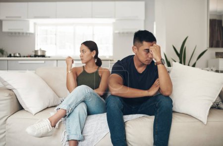 Divorce, angry or couple fight on sofa with anxiety, fear or frustrated by liar, stress or drama at home. Marriage, conflict or asian people argue in living room with blame, overthinking or mistake.