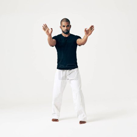 Photo for Studio, portrait and man in exercise of karate, martial arts training or gesture with hands on white background. Calm, fighter and person with skill in self defence technique or practice action. - Royalty Free Image