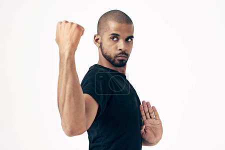 Photo for Karate, man and fight with fist in martial arts training or challenge with punch on white background. Strong, hands and person with skill in self defence technique or practice action in exercise. - Royalty Free Image