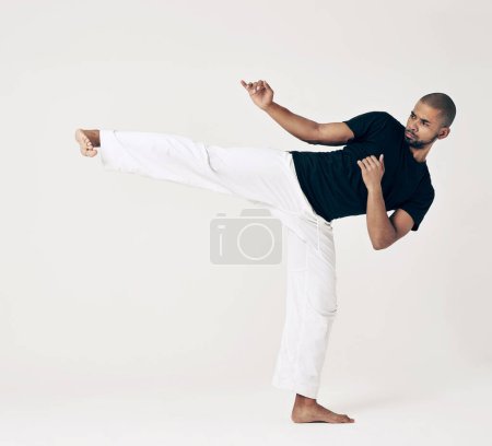 Photo for Martial arts, karate and man with training, fitness and wellness on a white studio background. Healthy person, fighter and model with practice and self defense with sports and striking with workout. - Royalty Free Image