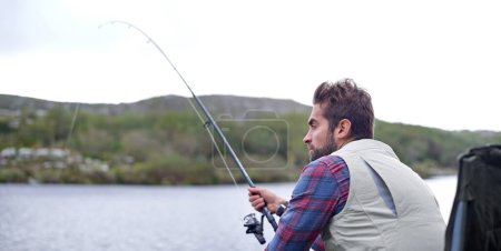 Photo for Fishing, lake and man with vacation, relax and hobby with environment, water and weekend break. Outdoor activity, peaceful and holiday with getaway trip or countryside with woods or travel with grass. - Royalty Free Image