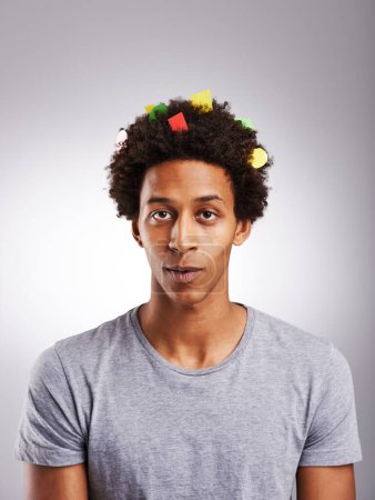 Photo for Portrait, black man or confetti in funny, prank or joke of creative, fail or oops on grey background. Gen z student, guilty or paper in artistic afro looking silly, messy or comic in studio mockup. - Royalty Free Image