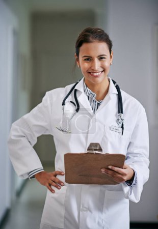 Smile, woman and portrait of doctor with clipboard in hospital reading medical data or information. Happy, checklist and female healthcare worker with charts, notes or research in medicare clinic
