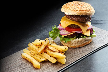 Photo for Beef, burger and fries on menu in restaurant with lettuce, tomato and cheese on bread in kitchen. Bbq, hamburger and fast food with meat, salad and potato chips in cafeteria diner for dinner or lunch. - Royalty Free Image