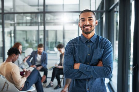 Photo for Man, smiling and excited in office portrait for new opportunity, internship or employment. Person, happy and colleagues meeting in background for collaboration, teamwork and partnership in workplace. - Royalty Free Image