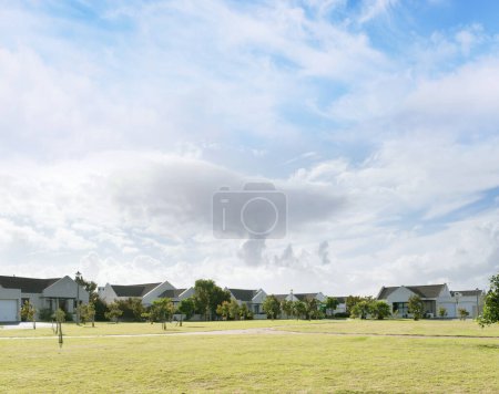 Photo for Residential area, sky and grass with secure park for walking, sports or playing summer games. Real estate, clouds and field for development, property management and housing with outdoor lawn. - Royalty Free Image