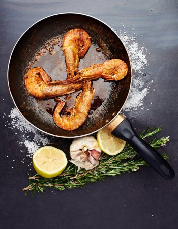 Photo for Healthy, food and prawns in pan on table for natural, organic and nutrition to prepare seafood dish. Fish, protein and wellness with vitamin B, minerals and prevents cancer or inflammation in muscles. - Royalty Free Image