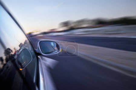 Photo for Car, mirror and moving on highway in road with speed, travel and driving fast for race or emergency. Vehicle, transport and motion blur in hurry on freeway, street and rush to work with insurance. - Royalty Free Image