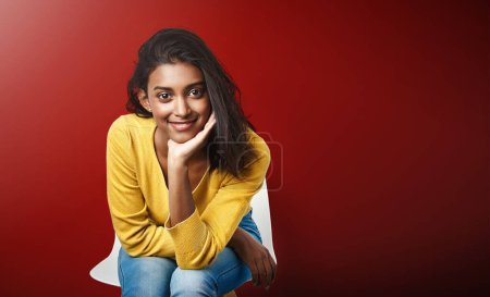 Portrait, recruitment or Indian girl in waiting room for hr meeting, help or career choice advice on red background. Hiring, internship or student at consultant office for job shadowing opportunity.