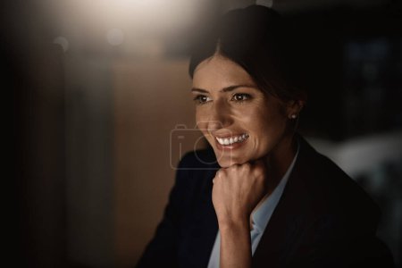 Photo for Thinking, night and business with woman, smile and reading email with positive news and research for project. Attorney, lawyer and compliance officer with online report, idea and company website. - Royalty Free Image