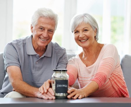 Photo for Savings, investment and portrait of old couple with money in jar for retirement, fund or future plan. Senior, finance and cash in piggy bank in home to budget income for increase in financial freedom. - Royalty Free Image