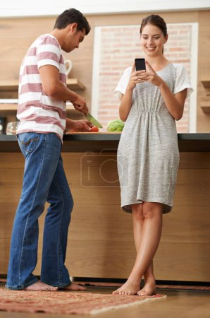 Photo for Influencer couple, vegetables and phone in kitchen for online content creation, ebook and nutrition in house. Man, woman and technology in apartment for digital, social media, and vegan cooking. - Royalty Free Image