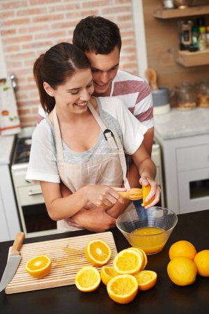 Photo for Couple, hug and fruit in orange juice with smile, health and wellness in winter or season. Man, woman and cheerful in preparing citrus for nutrition, vitamin c and diet for fresh, squeezed and drink. - Royalty Free Image