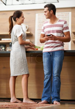 Photo for Couple, influencer and smartphone in kitchen for vegan website, social media and healthy in apartment. Happy man, woman and content creators in house for ebook, nutrition and organic for salad - Royalty Free Image