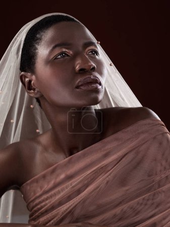 Photo for African, thinking or woman with makeup, scarf or confidence glow in studio on black background. Beauty, face or proud model with traditional wrap, eyeshadow cosmetics or creative fashion in Ghana. - Royalty Free Image