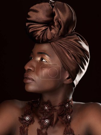 Photo for African, profile or woman with makeup, turban or necklace in studio on black background in Ghana. Skincare, face or model thinking of beauty, eyeshadow cosmetics and traditional fashion for culture. - Royalty Free Image