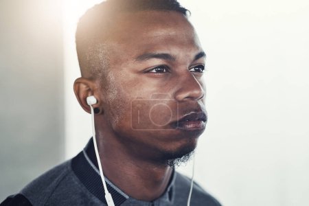 Photo for Fitness, earphones and man with thinking for exercise, workout planning and wellness podcast. Male person, serious and idea with headphones for music, audio streaming and cardio training in morning. - Royalty Free Image