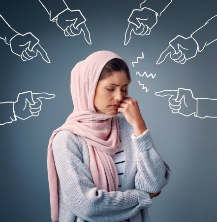 Photo for Bullying, pointing and muslim woman in studio hands, icon or emoji for discrimination in religion. Self esteem, peer pressure or ridicule for sad Islamic girl thinking on grey background with anxiety. - Royalty Free Image