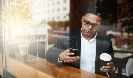 Photo for Coffee shop, business and man with smartphone, typing and texting contact for schedule and deadline. Person, employee and entrepreneur with morning tea and espresso with cellphone to message client. - Royalty Free Image