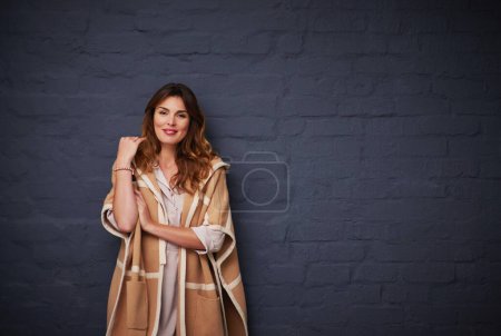 Photo for Fashion, beauty and portrait of woman by brick wall with stylish, trendy and elegant outfit. Cosmetic, winter and female model with classy clothes for style by dark black background with mockup - Royalty Free Image