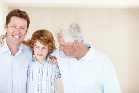 Photo for Grandpa, father and child hug in home for bonding, happy relationship and generations on wall background. Family, portrait and senior grandpa, dad and young boy embrace for love, weekend and relax. - Royalty Free Image