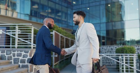 Photo for Businessman, handshake and meeting with colleague in city by steps outside building for greeting or introduction. Business people walking and shaking hands with employee for partnership or welcome. - Royalty Free Image