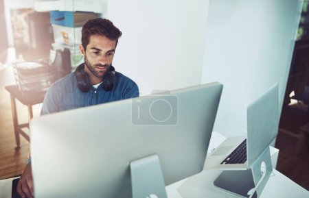 Photo for Serious, computer and business man in office for planning, reading email or network online in creative startup. Pc, programmer and code software for information technology, internet or cyber security. - Royalty Free Image
