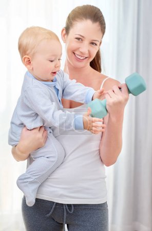Photo for Mother, baby and workout with dumbell for strong bond, learning and development with time management. Mom, child and home for motor skills or health with smile, exercise or training with weight. - Royalty Free Image