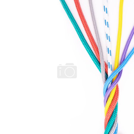Photo for Rope, ties or connection of colorful knot or braid on white background in studio for security. Tools, cords and abstract unity of rainbow society with texture together for hiking, climbing or safety. - Royalty Free Image