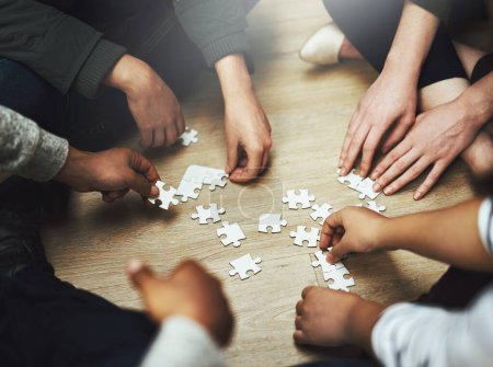 Photo for People, teamwork and hands with puzzle on floor for problem solving, support and integration of strategy. Team, diversity and training with jigsaw for creative interaction, collaboration and learning. - Royalty Free Image
